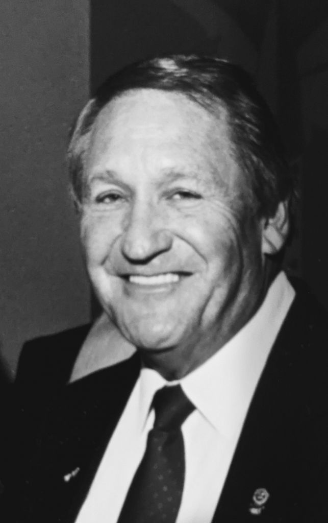 Black-and-white portrait of Laurence “Jack” Landriault smiling in a suit and tie